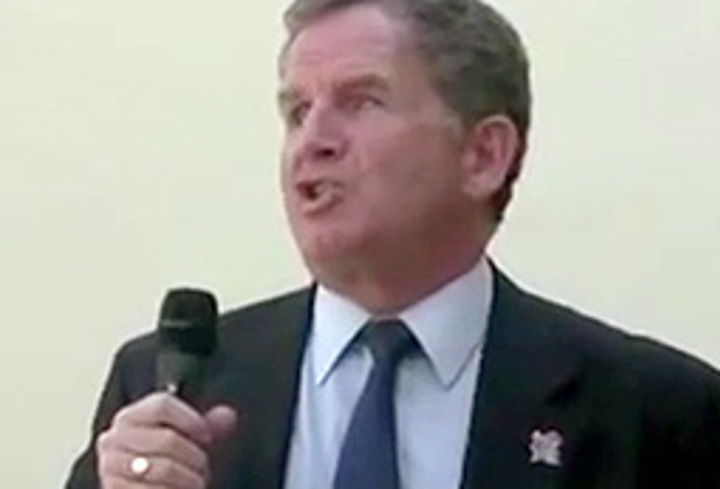 Photo showing Mike talking into a microphone